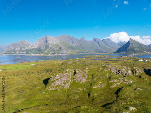 Aerial view of the North Atlantic coastal landscape near Fredvang, in background the distinctive peak of Volandstind, Lofoten Norway