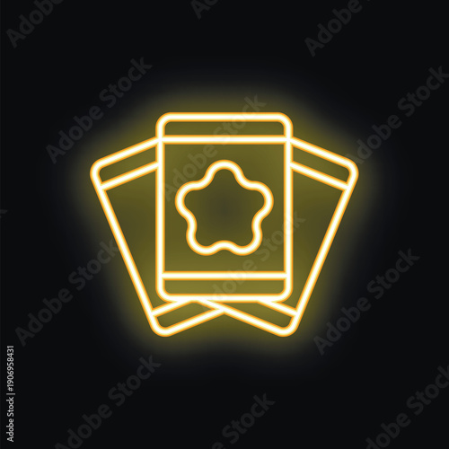 Yellow neon sign of three tarot cards, the top card facing forward and displaying a star, symbolizing destiny and fortune telling