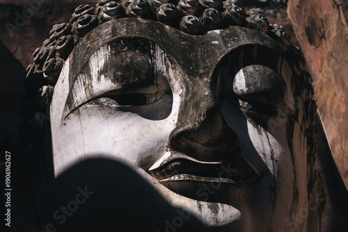 Fotografie Ancient Buddha statue at Sukhothai temple in Thailand, Buddhist stone sculpture