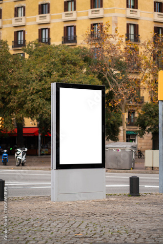 Blank billboard advertising display mockup standing on city street sidewalk, finding space for copy and urban branding in a modern public information panel
