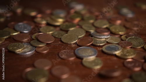 Many euro coins falling and accumulating in slow motion
