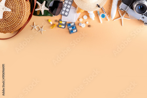 Tableau sur toile Summer holiday travel setup background including first aid kit with medications, pills, hat, and vacation accessories