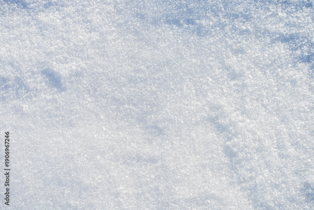 Obraz premium Natural snow texture with fine ice crystals creating a clean winter background. Minimal surface with copy space suitable for seasonal design, cold climate concepts and abstract winter visuals. 