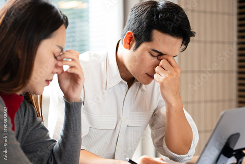 Quadro em tela Stressed  team with problem no solution at meeting, partners holding heads in hands depressed by failure bad news, feeling desperate about company bankruptcy or financial crisis