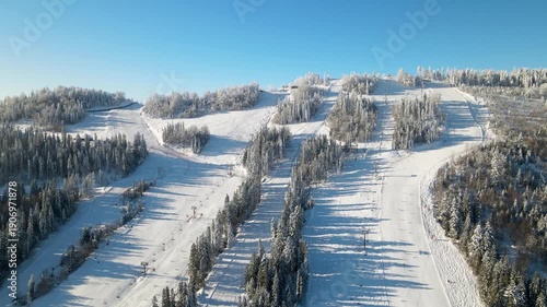 Wallpaper Mural Panoramic aerial drone view of ski or snowboard slope on bright sunny day. Ski or snowboard  resort in winter. Ukraine, Carpathians, Play. Aerial panoramic drone view from above, top view from drone.  Torontodigital.ca