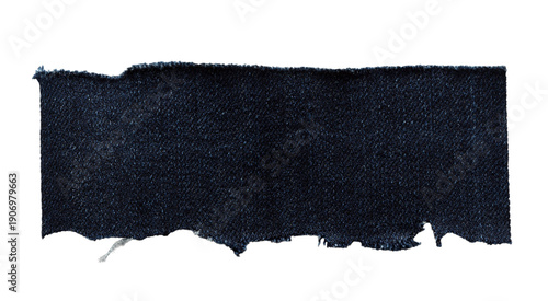 Torn dark denim fabric strip with frayed edge, cut out