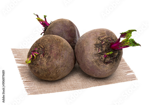 Raw beetroots with green leaves on burlap, isolate