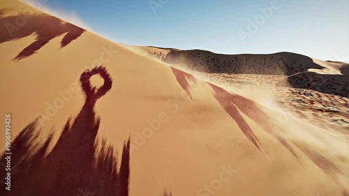 Vast desert sand dunes covered in intricate, colorful woven rug patterns.