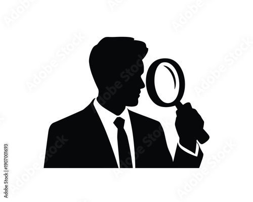 A silhouette of a man in a suit holding a magnifying glass