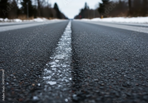 Close up shot of dangerous black ice covering a paved road surface, creating hazardous driving conditions in extreme cold weather, trouble, black ice, frozen