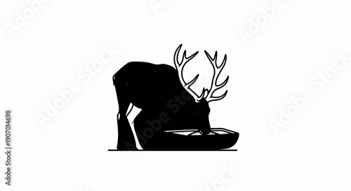 Silhouette of a deer with antlers drinking from a trough