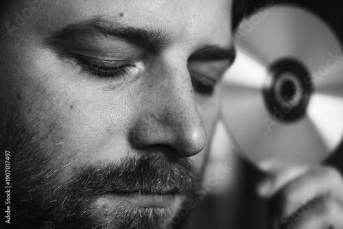 Фотография Close up man holding disc cd