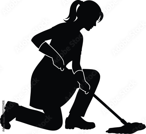 Woman kneeling on ground sweeping floor with broom in a domestic environment from side view
