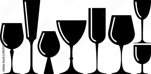 A set of crystal champagne wineglasses with gold bubbles and fizz stands isolated on a black background for a luxury New Year celebration toast