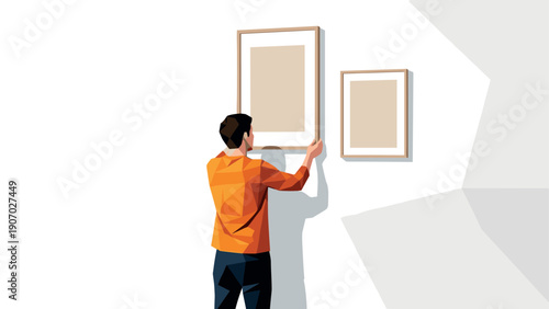 Man hanging geometric art in modern minimalist space