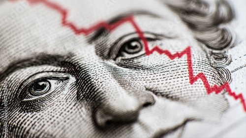 Economic Downturn Depicted by a Red Line Overlaying a Portrait on Currency Symbolizing Financial Crisis