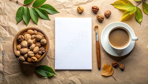 Cozy autumn morning creative workspace with coffee nuts and blank notepad.