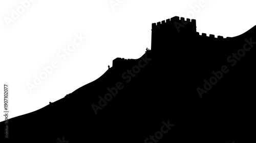 Silhouetted view of a castle on a hillside with watch towers