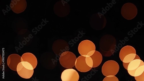Bright and Warm Bokeh Lights on a Dark Background for Festive and Celebratory Mood