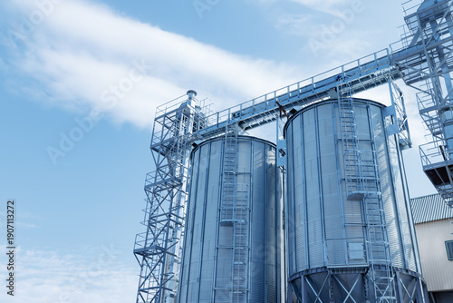Εκτύπωση καμβά Modern steel grain silos in agricultural complex against blue sky