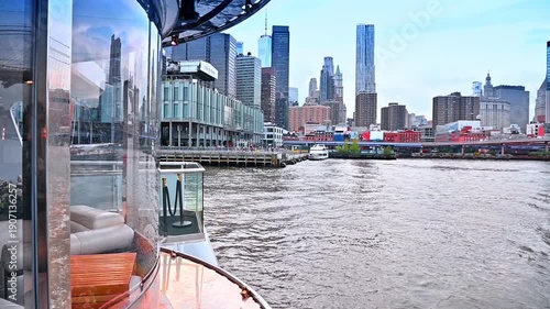 Travelling by the riverboat on the gloomy day. Footage from the board of the boat distancing from the pier of New York, USA.