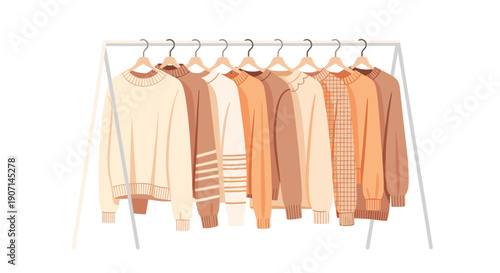 A collection of warm beige and brown sweaters of different styles and shades hangs neatly on a metal clothing rack.