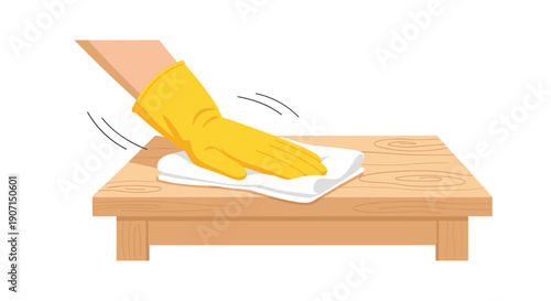 A gloved hand wearing a yellow protective glove is actively wiping a light brown wooden table surface with a clean white cloth.