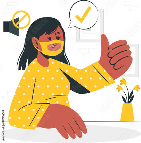 A young woman wearing a yellow face mask and giving a thumbs up gesture in a room with flowers on a table