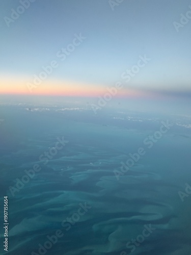 Obraz na plátně Aerial seascape over turquoise shallows at sunset