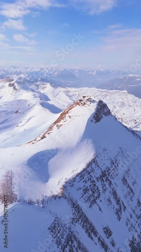 Hotel at the Top of Faulhorn Mountain on Sunny Winter Day. Snowy Bernese Alps. Switzerland. Aerial View. Moving Forward. Vertical Video