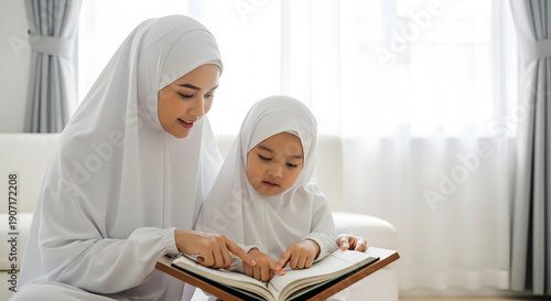 A realistic stock photo of a Muslim mother teaching her young daughter to read the Quran at home, both wearing modest white prayer clothing, child pointing at the pages of the Quran, gentle guidance a