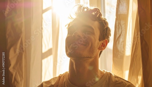 Intense sunlight illuminates a mans face near a window.