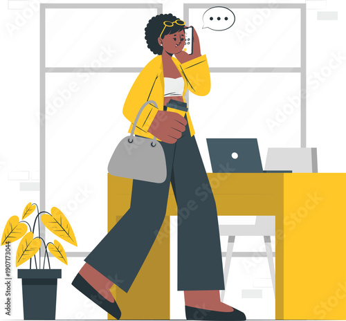 Woman talking on phone while working on laptop at desk in office environment