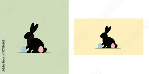 Cute black bunny with pink cheeks sitting on a light green background with a small blue patch