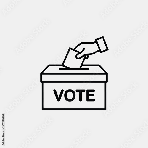 A hand inserting a ballot into a voting box labeled vote