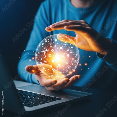 Man holding glowing crystal ball over laptop keyboard in dark room