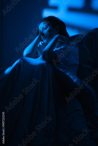 Photography Depressed woman suffering sleep disorder and insomnia sitting on the bed at nigh