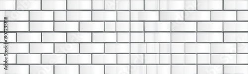 A wall of white rectangular tiles with dark grout creating a pattern