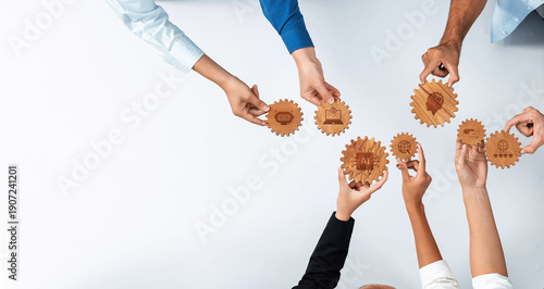 Obraz na plátně A diverse group of professionals collaborates using wooden gears, representing the power of teamwork and innovative ideas in a modern work environment, inspiring creativity