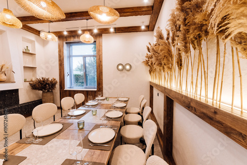 Boho private dining room set for dinner with rattan lamps and pampas wall