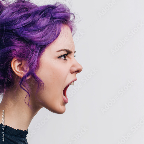 Young woman with vibrant purple hair screaming intensely