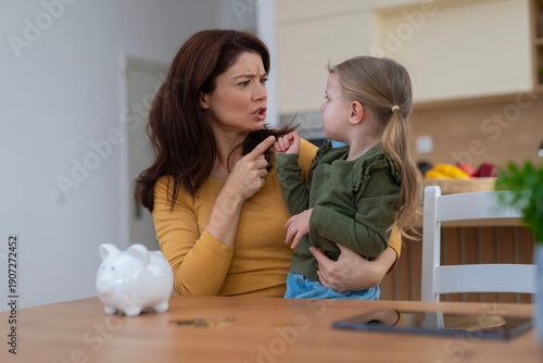 Φωτογραφία Mother scolding child about family money, financial discipline
