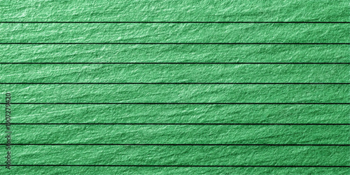 A close-up view of a textured green surface with visible brush strokes