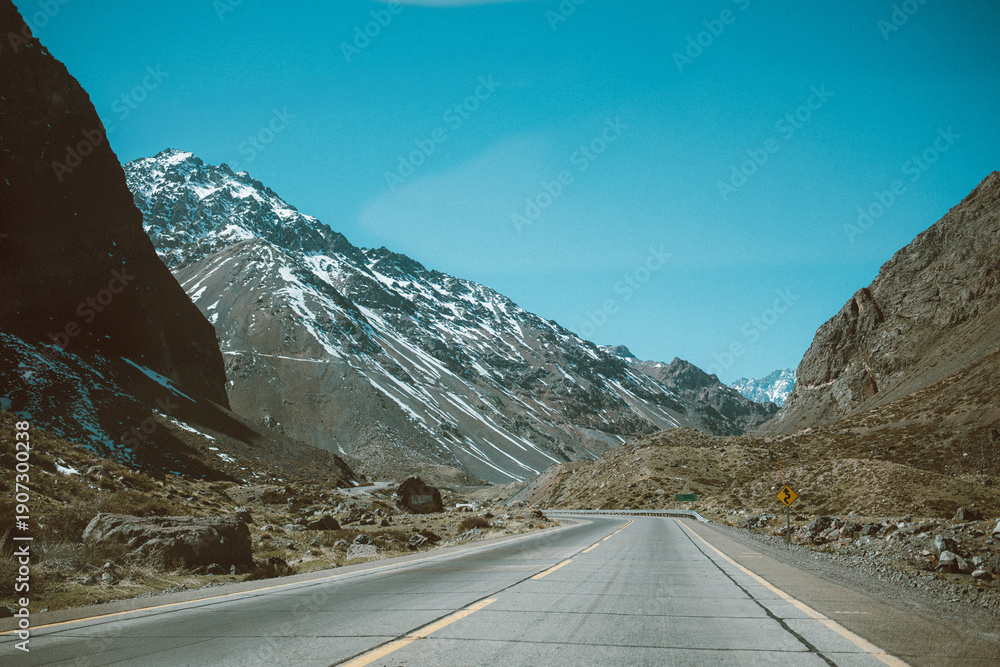 Fototapeta premium Mountain road crossing the Andes on the Chilean side under clear blue sky.