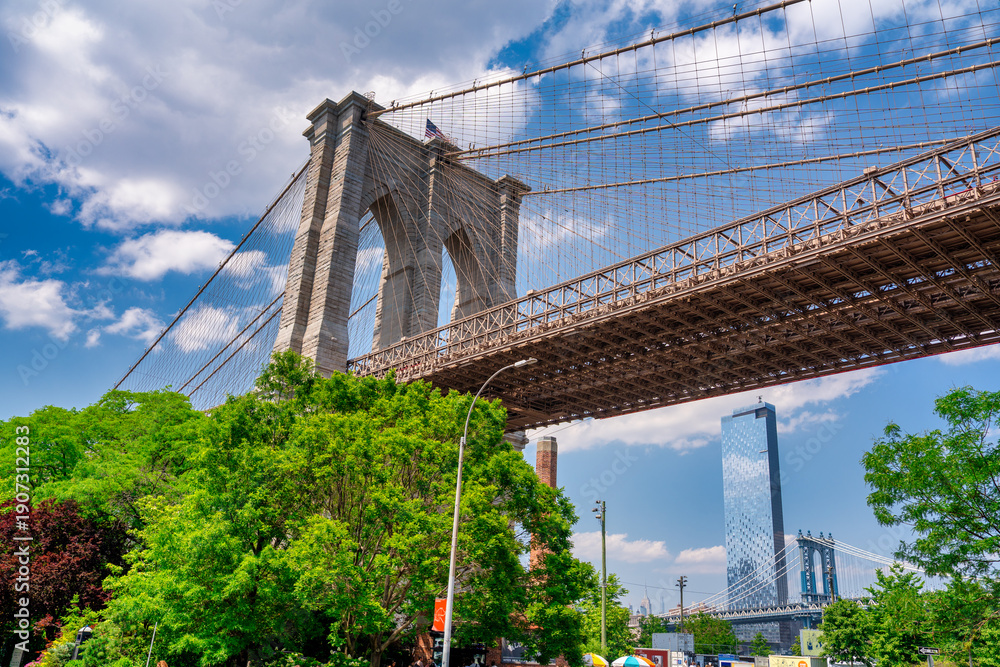 Fototapeta premium Iconic Brooklyn Bridge seen from Brooklyn Bridge Park during bright summer daylight, New York City
