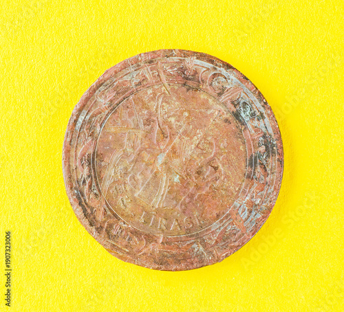 Wallpaper Mural Vintage Turkish coin with scratches lying on bright yellow background showing worn metal texture and historical details of old currency Torontodigital.ca