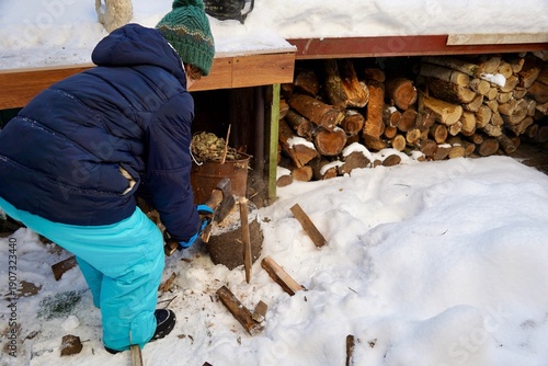 Child Chopping Wood Outdoors — Traditional Rural Activity