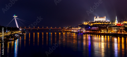 Photography Panorama of Bratislava with illuminated Bratislava Castle and modern bridge over