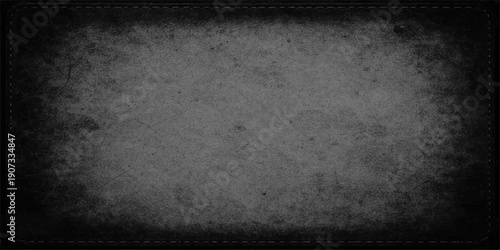 A dark vintage frame featuring a dirty grunge film strip textured with aged gray concrete and rough black paper patterns on an old stone backdrop surface
