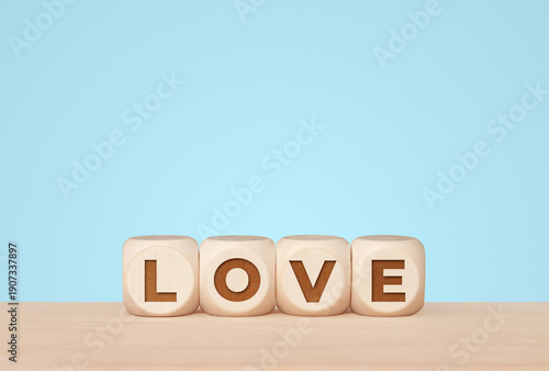 Love concept with letter cubes on light blue background